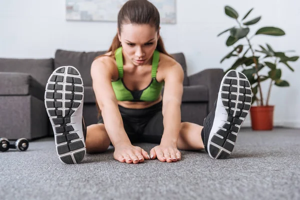 Selective Focus Sportswoman Sitting Doing Stretching Exercise Home — Stock Photo, Image