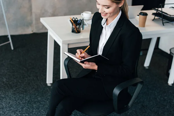 Beautiful Businesswoman Smiling Writing Notebook — Stock Photo, Image