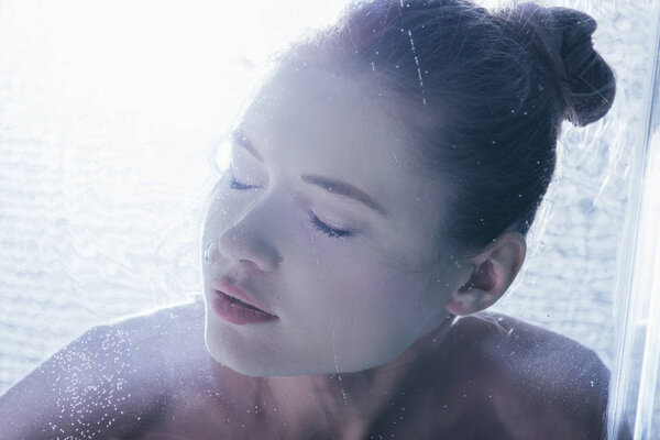 close up of beautiful girl posing underwater with closed eyes