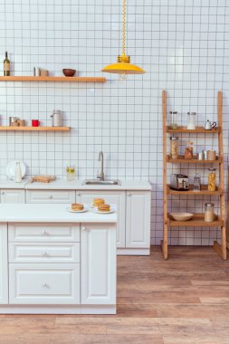 modern kitchen design with wooden shelves and white tile on background