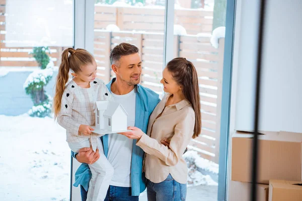 Cheerful Father Holding Arms Daughter While Looking Wife House Model — Stock Photo, Image