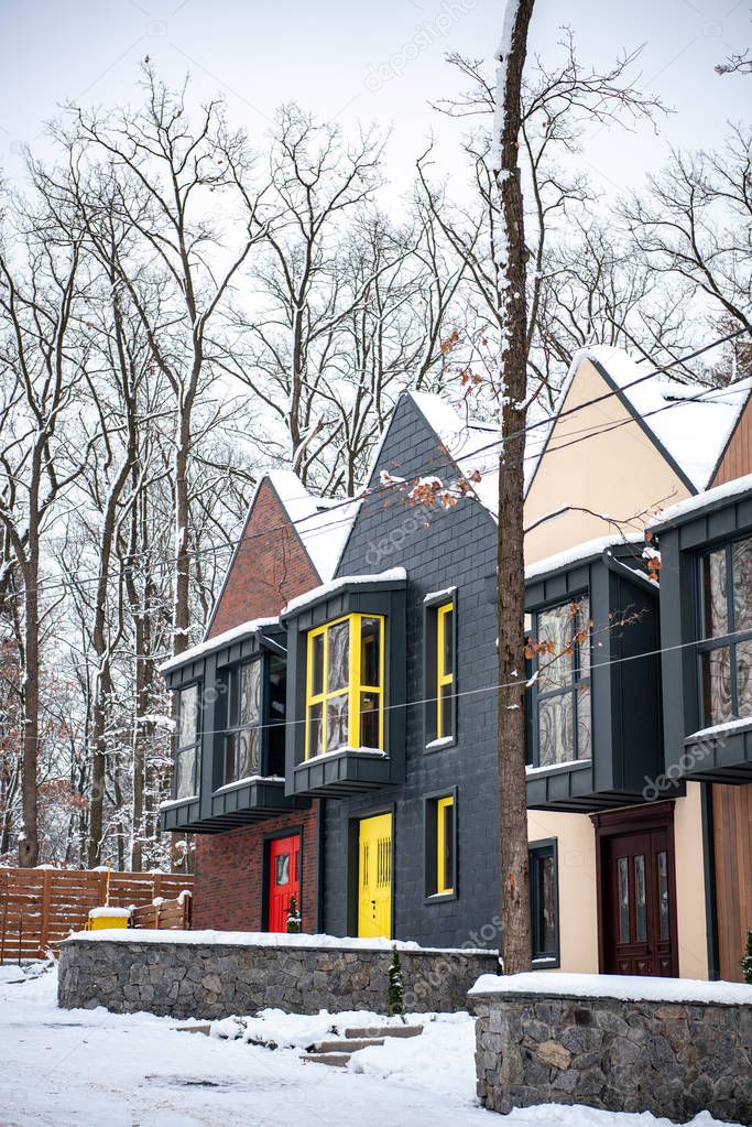 stylish modern buildings in cold winter with snow on roofs