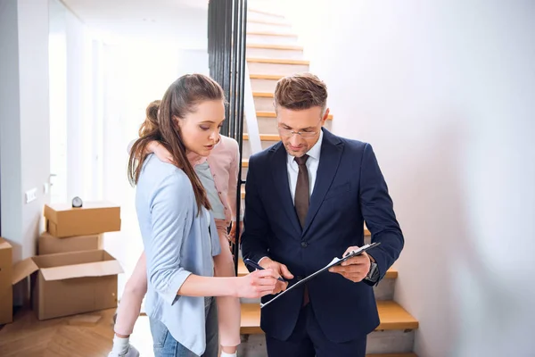 Attractive Woman Holding Arms Daughter Signing Document Broker Holding Clipboard — Stock Photo, Image