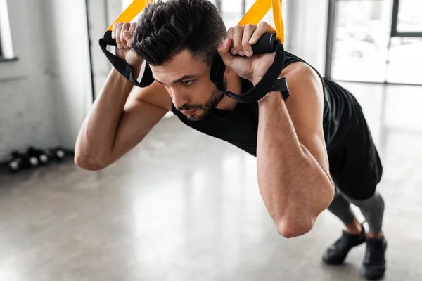 Close View Concentrated Sporty Man Hanging Fitness Straps Looking Away — Stock Photo, Image