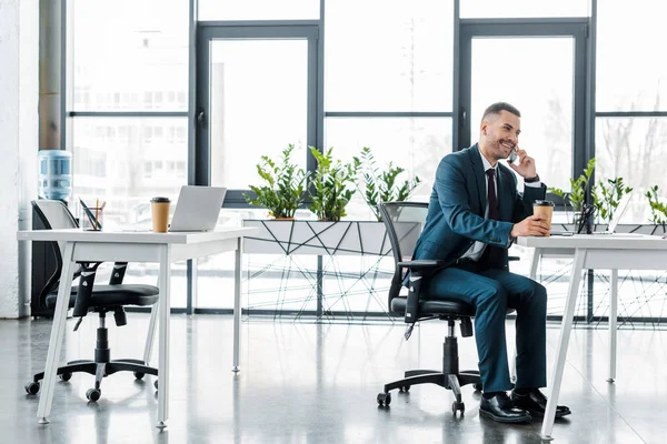 Businessman Holding Paper Cup While Talking Smartphone Modern Office — Stock Photo, Image