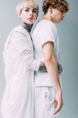 yakışıklı erkek gri izole sarılma dövmeler ile çekici kadın