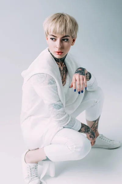 Blonde Woman Tattoos Sitting Grey Background — Stock Photo, Image