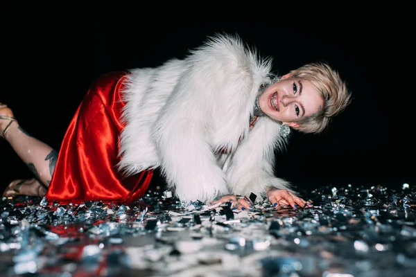 Cheerful Blonde Woman Tattoos Lying Floor Confetti Isolated Black — Stock Photo, Image