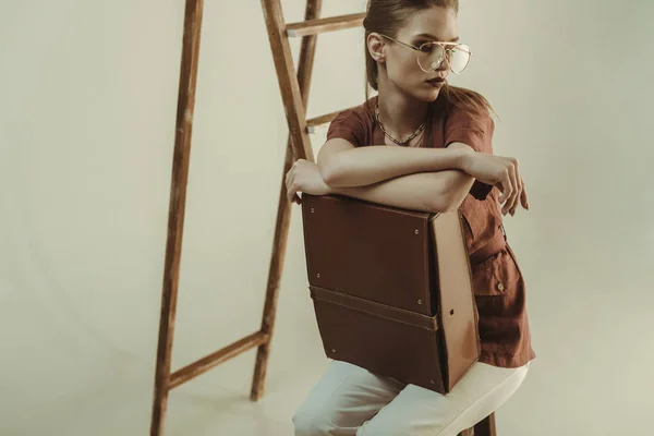 Attractive Young Model Holding Leather Bag Sitting Ladder Isolated Beige — Stock Photo, Image