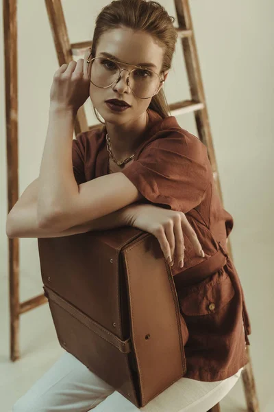 Beautiful Stylish Girl Holding Leather Bag Sitting Ladder Isolated Beige — Stock Photo, Image