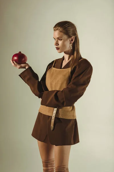 Beautiful Stylish Model Holding Fresh Pomegranate Isolated Beige — Stock Photo, Image