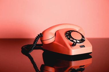 Living coral vintage rotary telephone. Pantone color of the year 2019 concept clipart