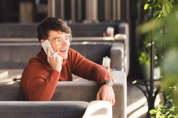 Smiling Young Man Glasses Talking Smartphone While Sitting Cafe — Stock Photo, Image