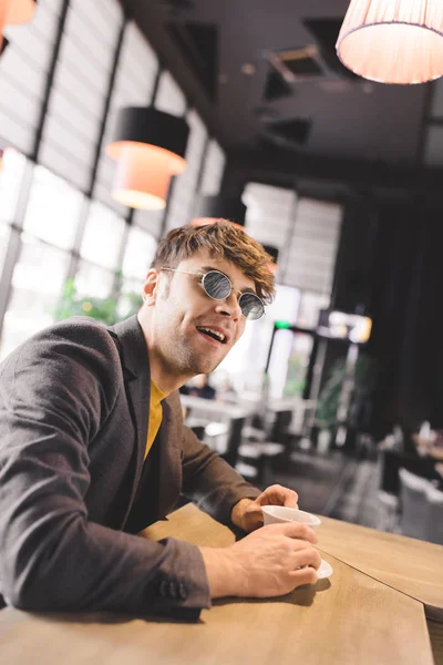 Cheerful Young Man Sunglasses Sitting Bar Counter Cup Coffee — Stock Photo, Image