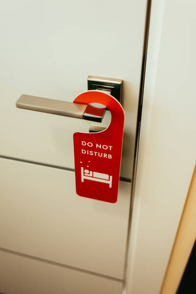 door handle with red "do not disturb" symbol in hotel