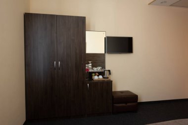 hotel room interior with wardrobe and mirror clipart
