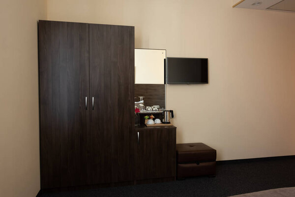 hotel room interior with wardrobe and mirror