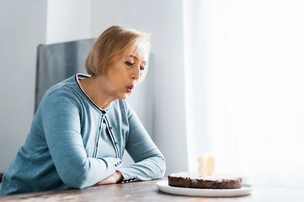 Senior Woman Blowing Out Candles Cake Sign Top Birthday Celebration — Stock Photo, Image