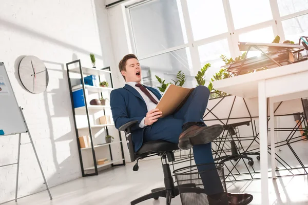 Tired Businessman Yawning While Holding Notebook Office — Stock Photo, Image