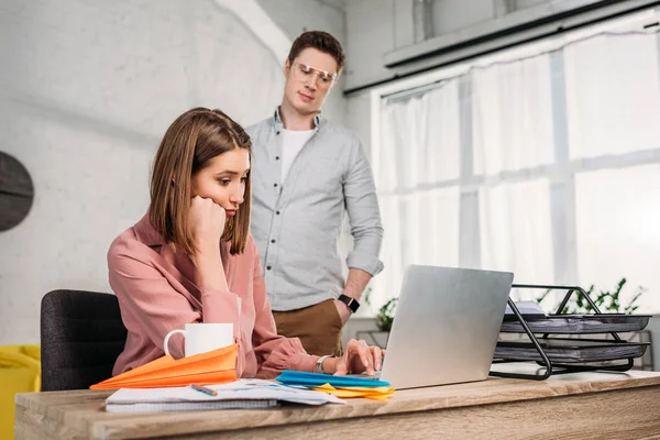 Handsome Man Looking Tired Girlfriend Sitting Laptop Home — Stock Photo, Image