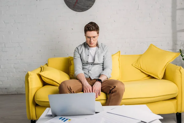 Tired Man Glasses Sitting Sofa Looking Laptop Home — Stock Photo, Image