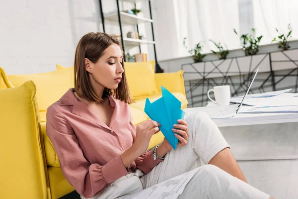 Tired Woman Sitting Floor Looking Paper Plane Home — Stock Photo, Image