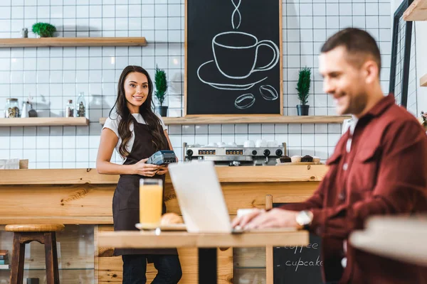 Selective Focus Waitress Standing Bar Counter Terminal Wile Freelancer Burgundy — Stock Photo, Image