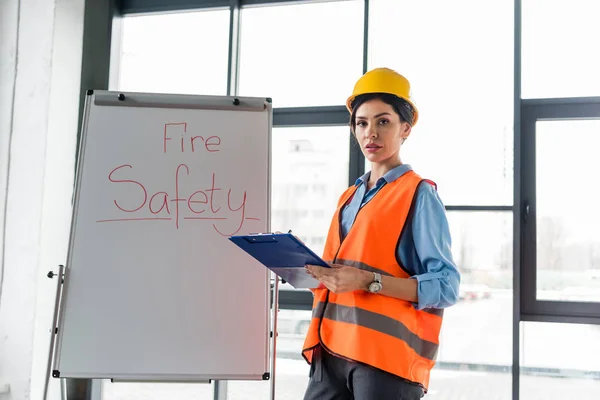 Attractive Firefighter Helmet Holding Clipboard While Standing White Board Fire — Stock Photo, Image