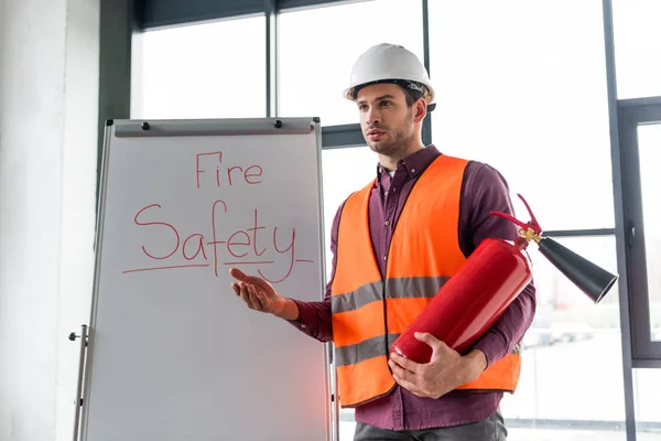 Schöner Feuerwehrmann Mit Rotem Feuerlöscher Während Der Nähe Einer Weißen — Stockfoto