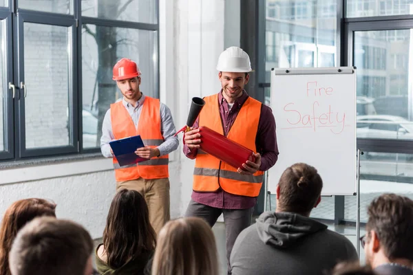 Selective Focus Handsome Firemen Helmets Standing White Board Fire Safety — Stock Photo, Image
