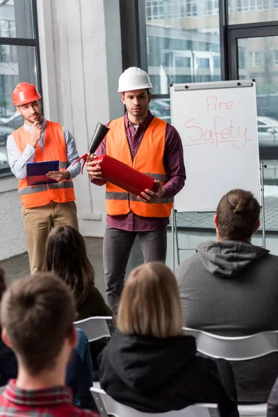 Selective Focus Handsome Firefighters Helmets Standing White Board Fire Safety — Stock Photo, Image