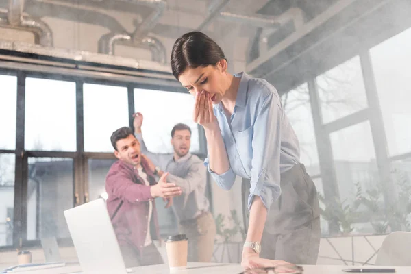 Businesswoman Holding Nose While Standing Coworkers Office Smoke — Stock Photo, Image