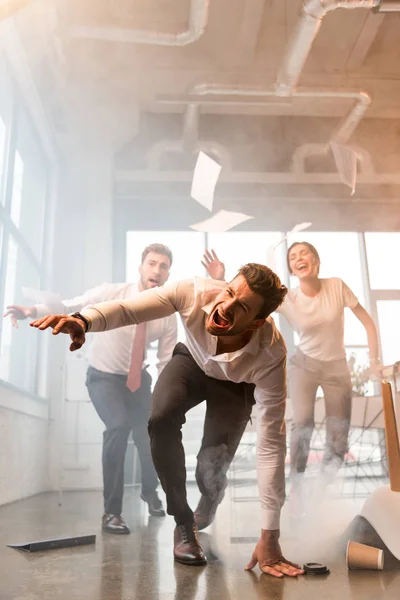 Terrified Businessman Falling Floor While Running Screaming Coworkers Office Smoke — Stock Photo, Image