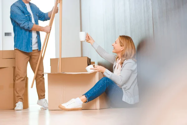 Selective Focus Woman Sitting Floor Unpacking Cardboard Box — Stock Photo, Image