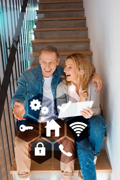Excited Couple Talking While Sitting Stairs Using Digital Tablet Smart — Stock Photo, Image