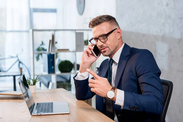 Handsome Businessman Glasses Suit Talking Smartphone Laptop Office — Stock Photo, Image