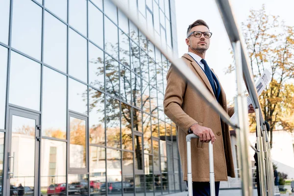 Handsome Businessman Standing Beige Coat Holding Business Newspaper Suitcase — Stock Photo, Image