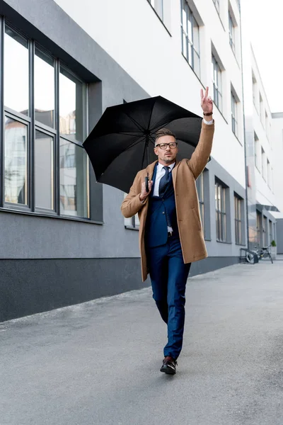 Handsome Businessman Glasses Gesturing While Running Beige Coat Umbrella — Stock Photo, Image