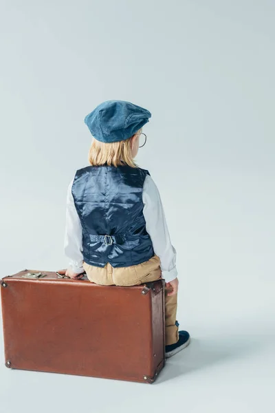 Back View Kid Retro Vest Cap Sitting Suitcase Grey Background — Stock Photo, Image