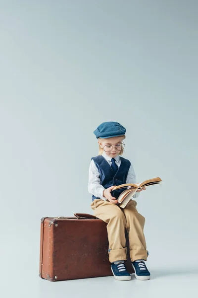 Kid Retro Vest Cap Sitting Suitcase Reading Book Grey Background — Stock Photo, Image