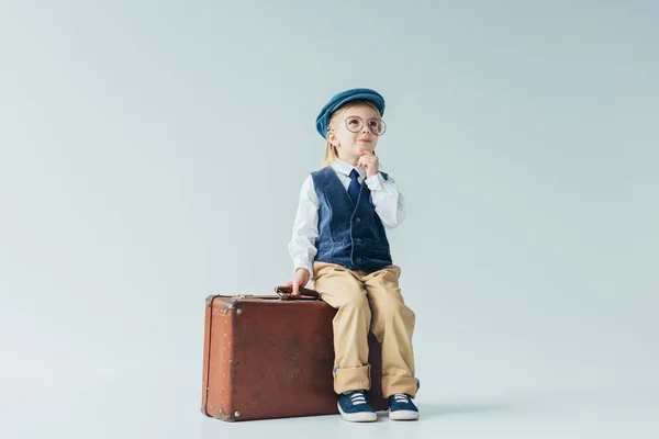 Pensive Kid Retro Vest Cap Sitting Suitcase Grey Background — Stock Photo, Image