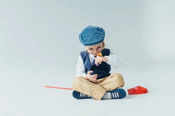 Cute Kid Sitting Floor Crossed Legs Holding Butterfly Grey Background — Stock Photo, Image