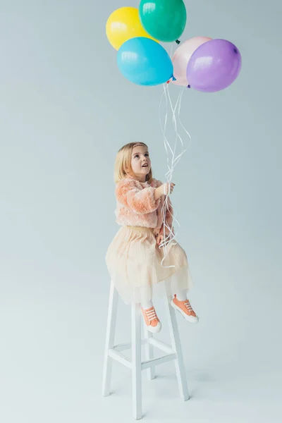 Cute Kid Faux Fur Coat Skirt Sitting Highchair Holding Balloons — Stock Photo, Image