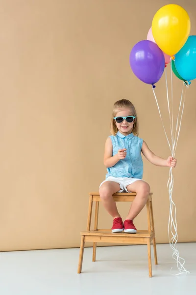 Cute Kid Sunglasses Shirt Shorts Sitting Stairs Balloons Looking Camera — Stock Photo, Image