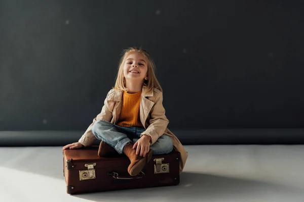 Smiling Cute Child Sitting Crossed Legs Leather Suitcase Black Background — Stock Photo, Image