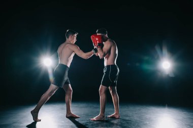 strong sportsmen in boxing gloves fighting during training  clipart