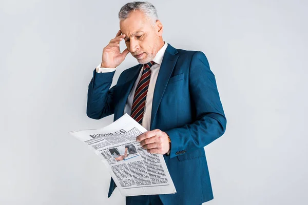 Mature Businessman Holding Head While Reading Business Newspaper Isolated Grey — Stock Photo, Image