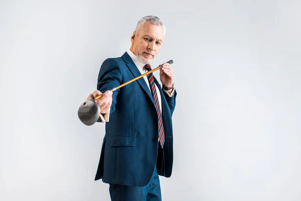 Selective Focus Concentrated Mature Man Suit Looking Golf Club Isolated — Stock Photo, Image
