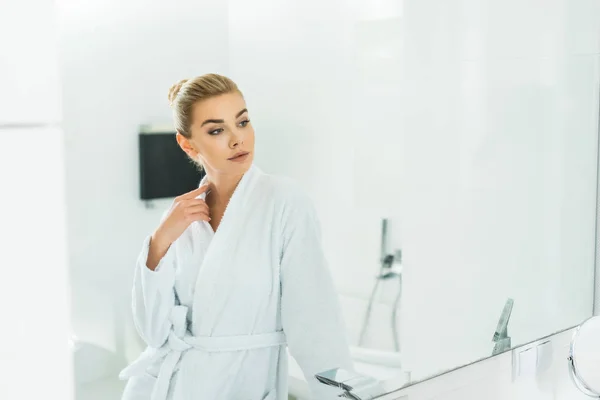 Beautiful Blonde Woman White Bathrobe Looking Mirror Bathroom — Stock Photo, Image