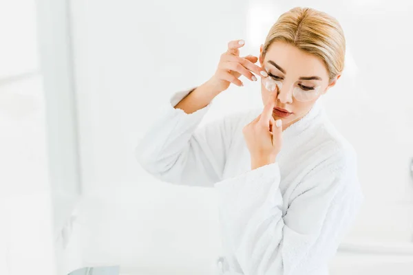 Beautiful Blonde Woman White Bathrobe Applying Eye Patches Bathroom — Stock Photo, Image